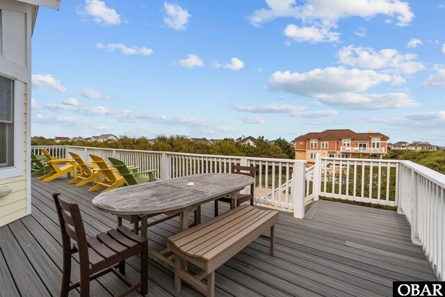 deck with a residential view and outdoor dining space