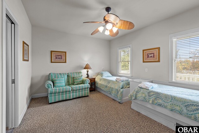 carpeted bedroom with baseboards and ceiling fan