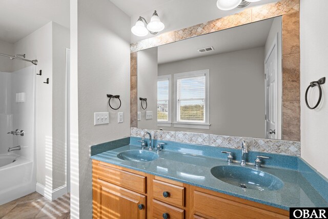 bathroom featuring a sink, shower / bath combination, double vanity, and visible vents