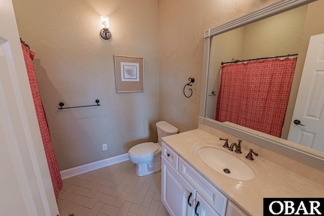 24280 NC Highway 12 Unit 2A, Rodanthe, NC 27968 - bathroom with toilet, baseboards, curtained shower, and vanity