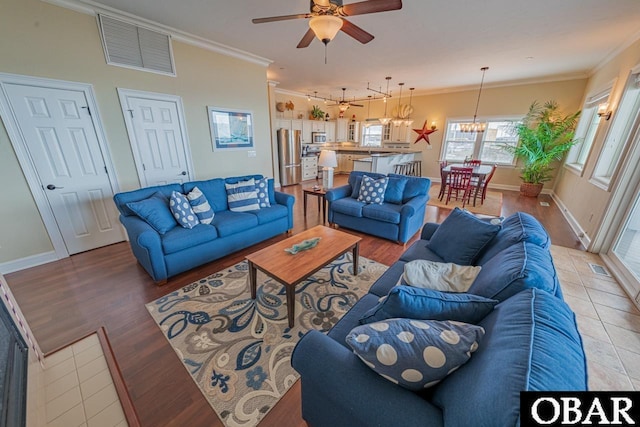 24280 NC Highway 12 Unit 2A, Rodanthe, NC 27968 - living area with crown molding, baseboards, ceiling fan with notable chandelier, and visible vents