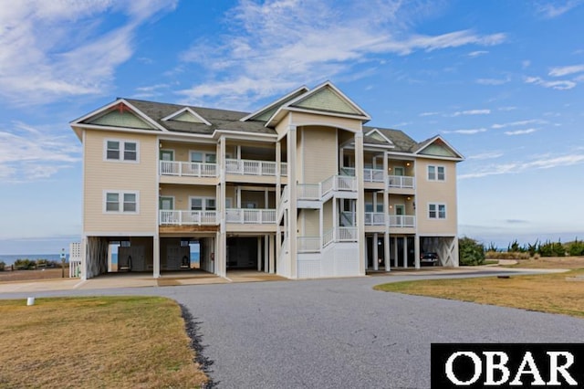 24280 NC Highway 12 Unit 2A, Rodanthe, NC 27968 - view of building exterior with a carport and aphalt driveway