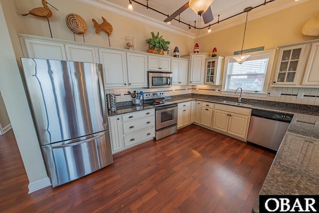 24280 NC Highway 12 Unit 2A, Rodanthe, NC 27968 - kitchen featuring decorative backsplash, appliances with stainless steel finishes, a sink, track lighting, and ornamental molding
