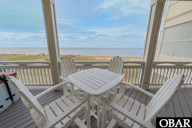 24280 NC Highway 12 Unit 2A, Rodanthe, NC 27968 - wooden deck featuring a view of the beach, outdoor dining space, and a water view