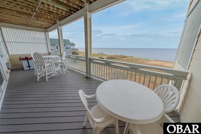 24280 NC Highway 12 Unit 2A, Rodanthe, NC 27968 - wooden terrace featuring outdoor dining area and a water view