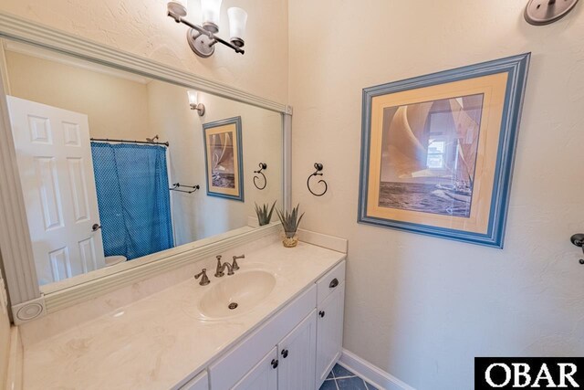 24280 NC Highway 12 Unit 2A, Rodanthe, NC 27968 - full bathroom featuring a shower with curtain, baseboards, and vanity