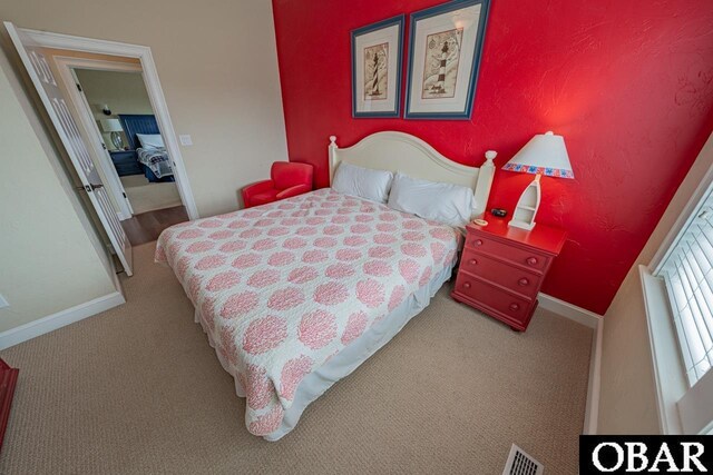 24280 NC Highway 12 Unit 2A, Rodanthe, NC 27968 - bedroom featuring carpet flooring, baseboards, and visible vents