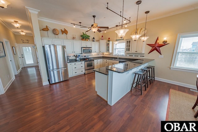 24280 NC Highway 12 Unit 2A, Rodanthe, NC 27968 - kitchen with a sink, crown molding, stainless steel appliances, and a peninsula