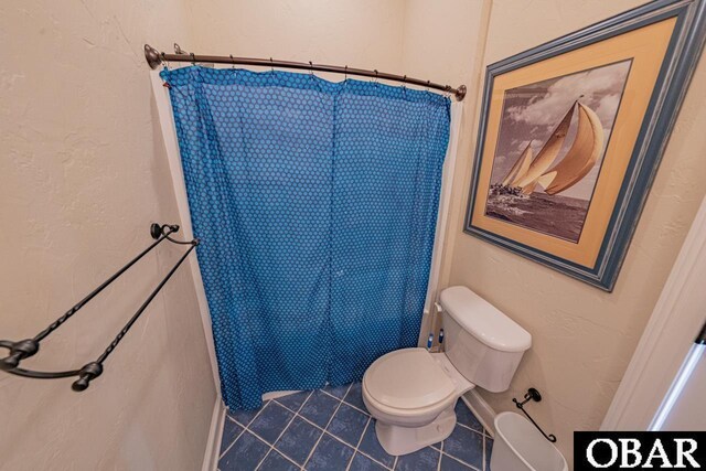 24280 NC Highway 12 Unit 2A, Rodanthe, NC 27968 - bathroom with toilet, tile patterned floors, and curtained shower