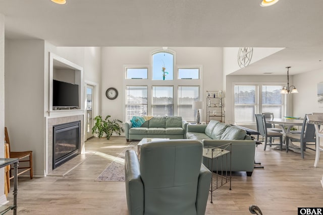 1700 Paget Rd Unit B3, Kill Devil Hills, NC 27948 - living area with a tile fireplace, light wood finished floors, and a chandelier