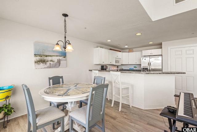 1700 Paget Rd Unit B3, Kill Devil Hills, NC 27948 - dining area with light wood-type flooring, recessed lighting, baseboards, and a chandelier