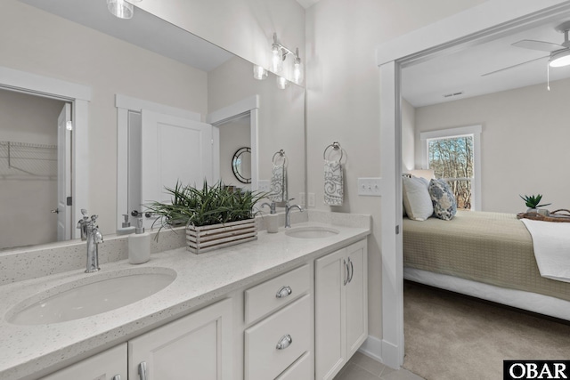 full bath with a sink, a ceiling fan, double vanity, and ensuite bathroom