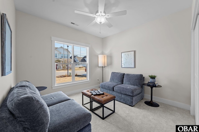 carpeted living room with visible vents, ceiling fan, and baseboards