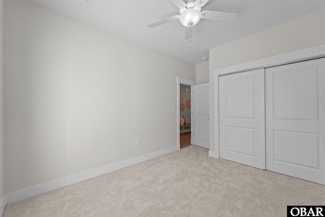 unfurnished bedroom with a ceiling fan, carpet, baseboards, and a closet