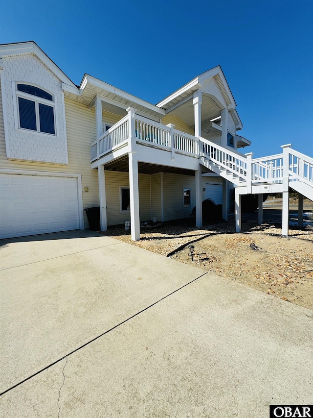 view of front of home with driveway, stairway, and an attached garage