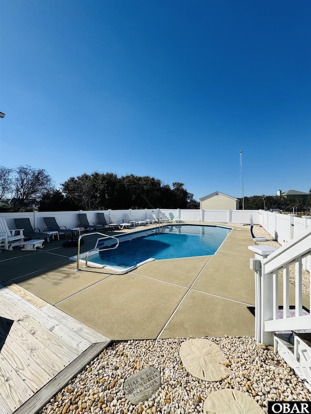 view of pool featuring a fenced backyard, a fenced in pool, and a patio