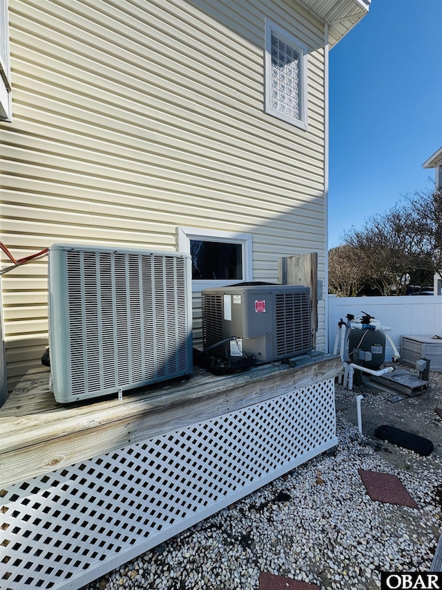 exterior space with central AC, fence, and a wooden deck