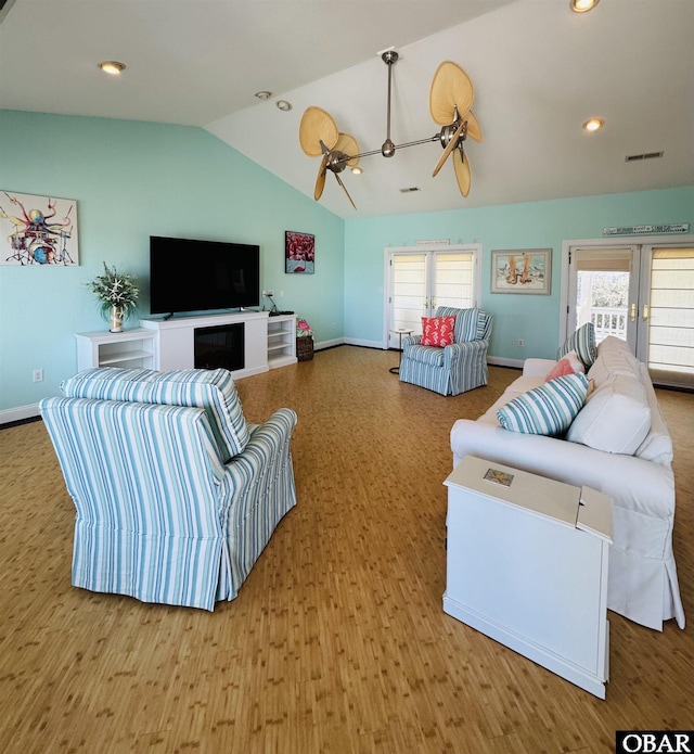 living room featuring lofted ceiling, plenty of natural light, visible vents, and recessed lighting