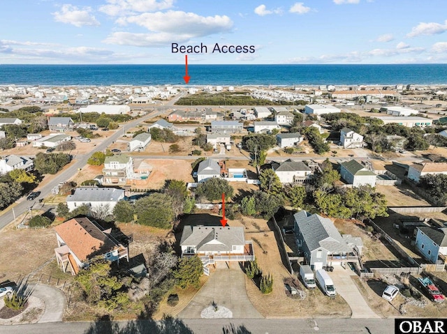 drone / aerial view with a water view and a residential view