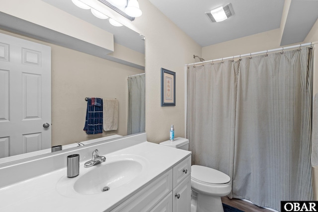 bathroom featuring toilet, visible vents, a shower with shower curtain, and vanity