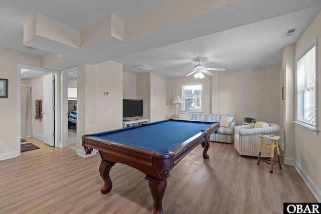 game room featuring plenty of natural light, light wood-style flooring, and visible vents