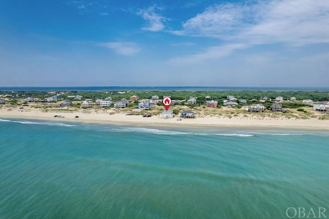 birds eye view of property featuring a water view and a view of the beach