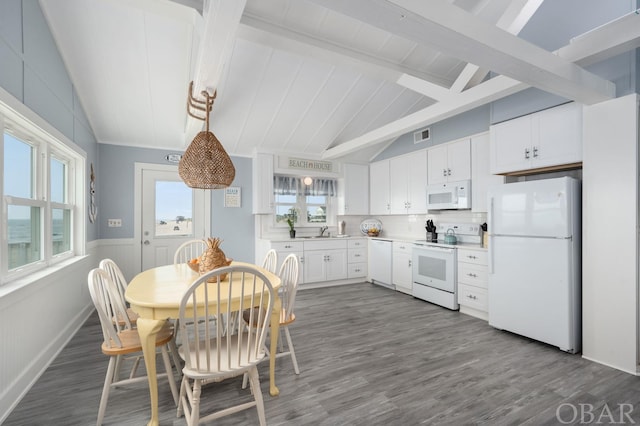 kitchen with vaulted ceiling with beams, white appliances, dark wood-style flooring, white cabinets, and light countertops