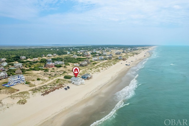 drone / aerial view featuring a water view and a beach view