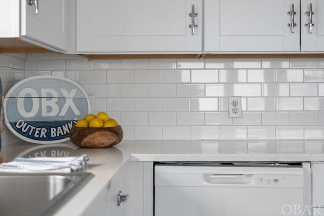 details with light stone counters, white dishwasher, backsplash, and white cabinets