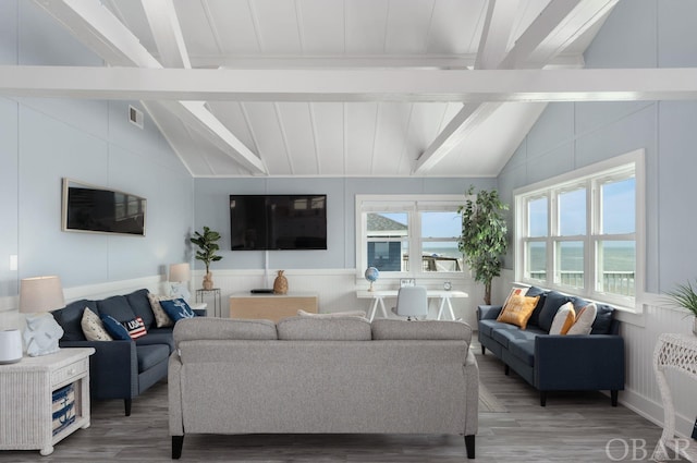 living room featuring lofted ceiling with beams, visible vents, and a healthy amount of sunlight