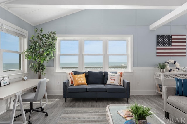 office featuring lofted ceiling, a wainscoted wall, a water view, and wood finished floors