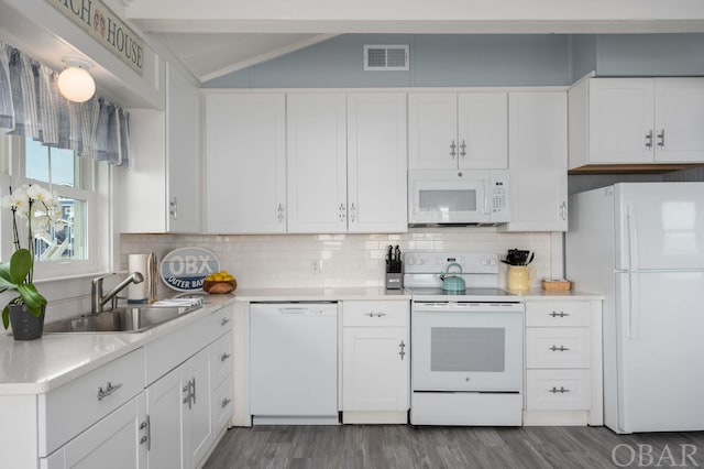 kitchen with white appliances, visible vents, white cabinets, light countertops, and a sink