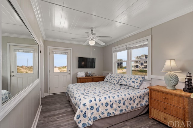 bedroom featuring dark wood-style floors, multiple windows, ornamental molding, and a ceiling fan