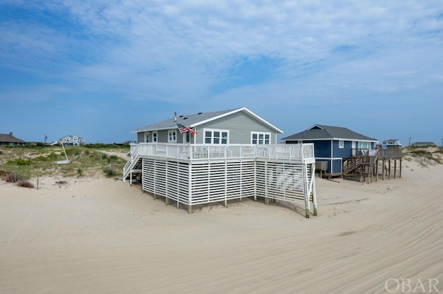 back of property featuring stairway and a wooden deck