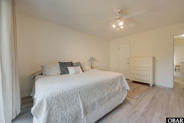 bedroom with light wood-style flooring and a ceiling fan