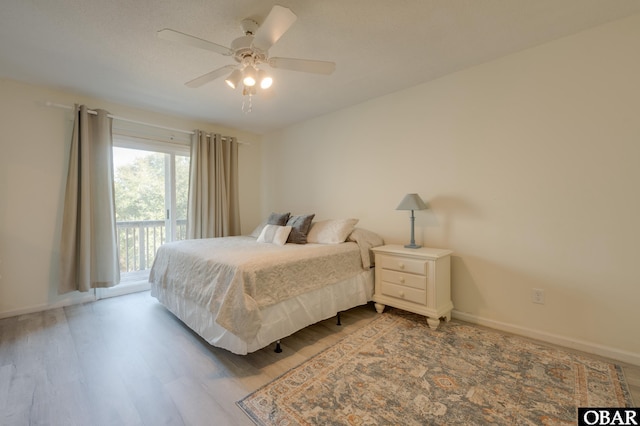 bedroom with ceiling fan, baseboards, access to outside, and wood finished floors