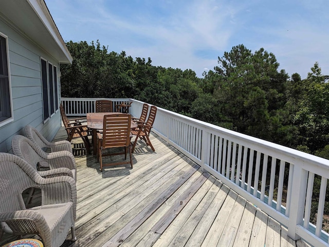 wooden deck featuring outdoor dining space