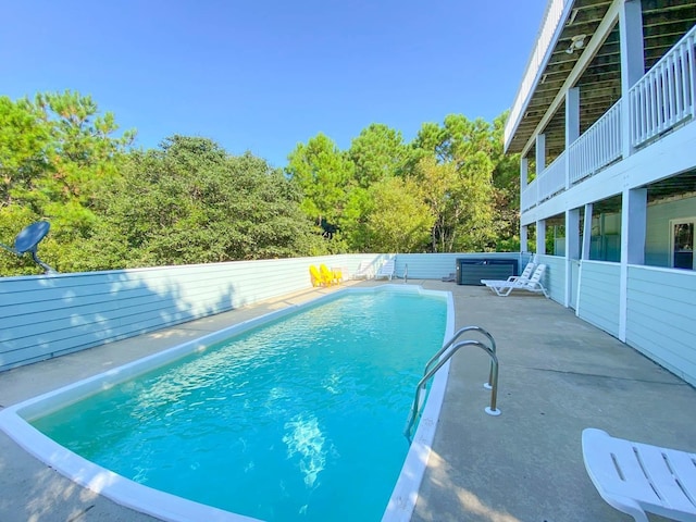 view of swimming pool with a patio area, a fenced in pool, and a hot tub