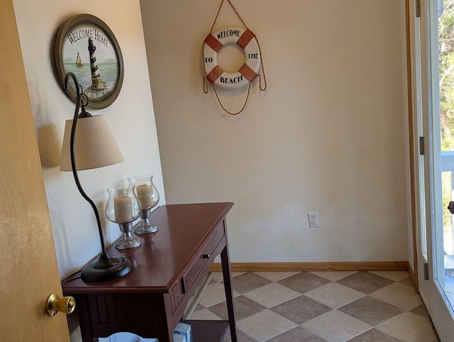 entryway with tile patterned floors and baseboards