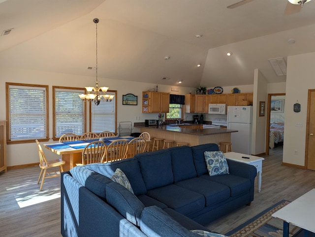 living area featuring baseboards, a chandelier, visible vents, and light wood-style floors