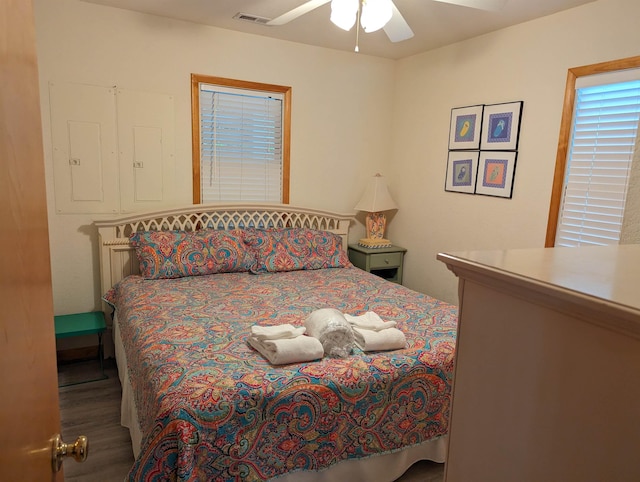 bedroom featuring visible vents, a ceiling fan, and wood finished floors