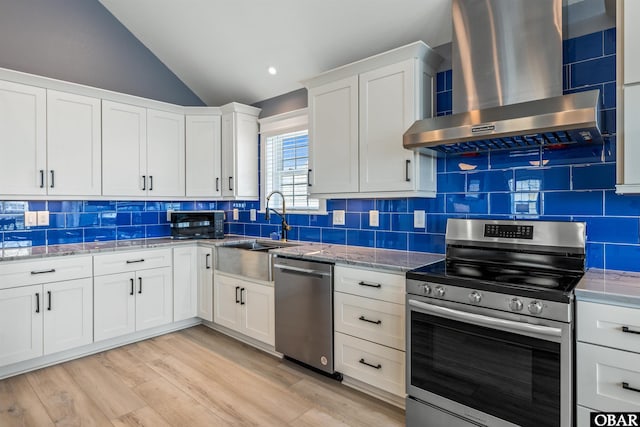 1726 Bobby Lee Trl Lot 5, Kill Devil Hills, NC 27948 - kitchen featuring appliances with stainless steel finishes, wall chimney exhaust hood, a sink, lofted ceiling, and decorative backsplash