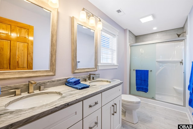 1726 Bobby Lee Trl Lot 5, Kill Devil Hills, NC 27948 - bathroom with toilet, a stall shower, double vanity, and wood finished floors