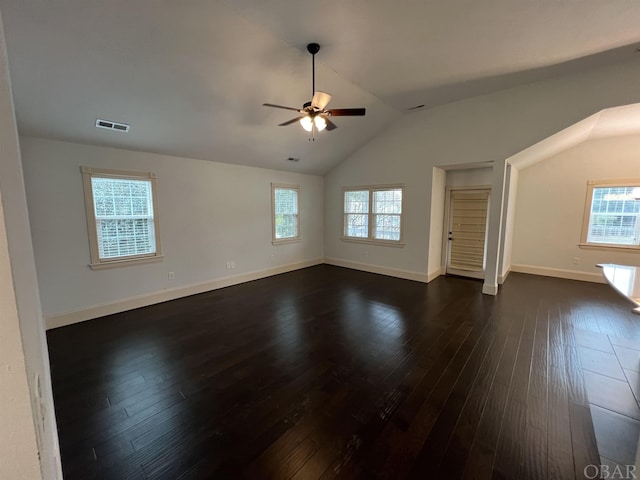 interior space featuring lofted ceiling, visible vents, dark wood finished floors, and ceiling fan