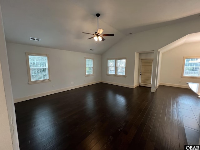 interior space with a ceiling fan, dark wood-style flooring, visible vents, and vaulted ceiling