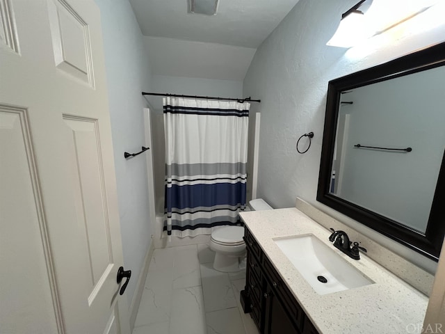 bathroom with a textured wall, toilet, vanity, marble finish floor, and shower / bath combo