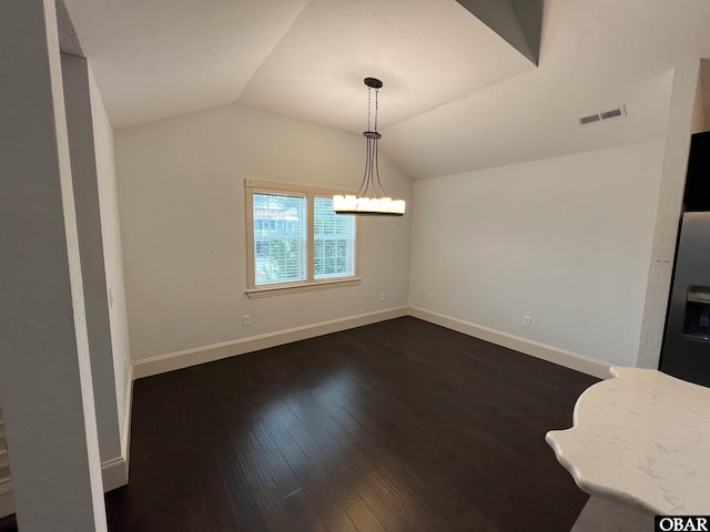 unfurnished dining area with baseboards, visible vents, dark wood-style flooring, vaulted ceiling, and a chandelier