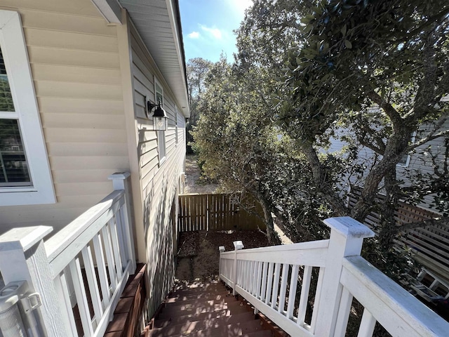 view of home's exterior with fence and a deck