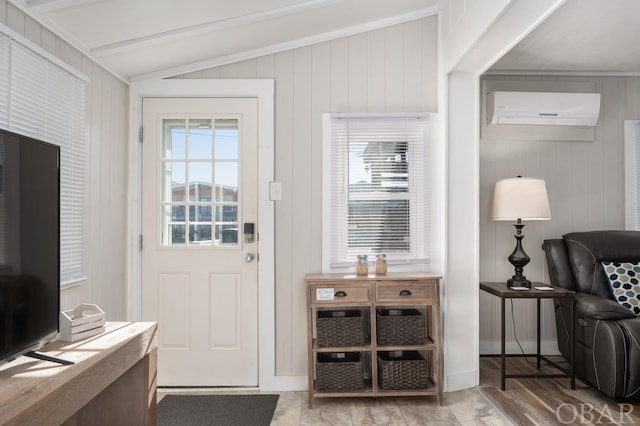 doorway with lofted ceiling and an AC wall unit