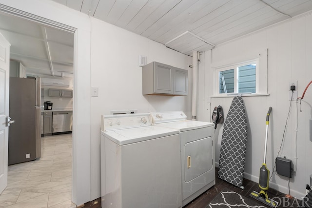 laundry area featuring cabinet space, visible vents, wood ceiling, marble finish floor, and washing machine and dryer